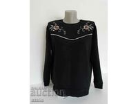 Black quilted blouse with two flower ornaments, size M