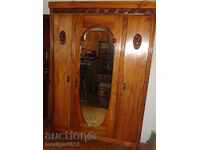 Old wardrobe made of walnut wood carving Venetian mirror